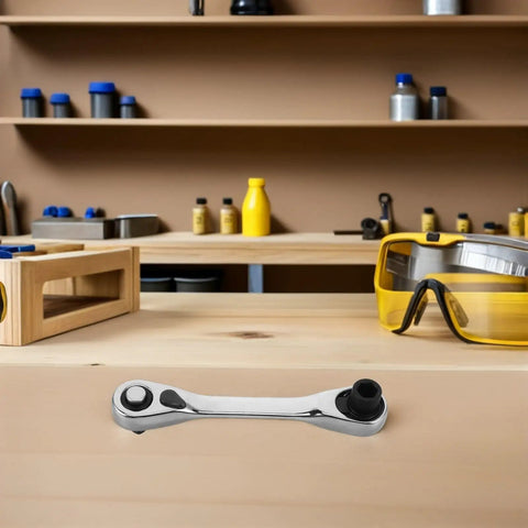 Rock Solid Mini Ratchet Wrench With 1/4 Inch Double Ended Reversible Socket And Knurled Finger Grip on a workbench.