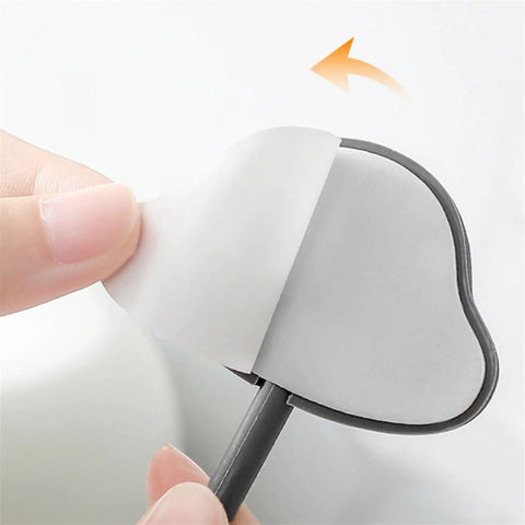 3 Pc Wall Mounted Hooks Set Grey Creative Home Storage Solution For Keys Towels And Sundries showing adhesive backing being peeled.