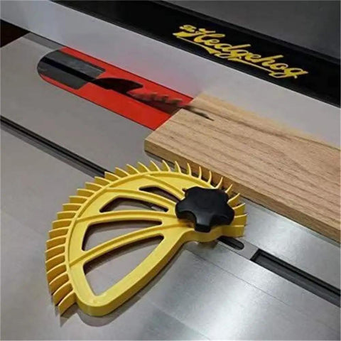 Table saw with yellow woodworking push block beside wood piece