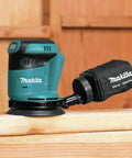 Cordless 5 Inch Random Orbit Sander 18V LXT With Three Speed Settings 7000 9500 11000 OPM on wood surface