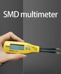 Digital Multimeter With LED Clip Probes For Non Solder Testing held in hand, showing yellow body and LED clip probes.