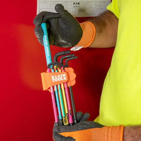 Technician holding color coded hex key wrench set with long arm L style and ball end SAE and metric 18 piece kit