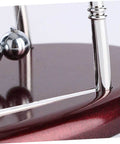 Close-up of Large Newton Cradle Pendulum Desktop Physics Toy For Home Office Use Five Ball Demonstration, polished wood base