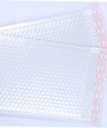 White Bubble Mailers 24x35cm Plus 5cm Padded Envelopes Shockproof Packaging Bags, two shown overlapping with self-seal strips visible
