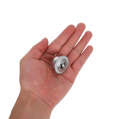 Hand holding one of the Six Pack Stainless Steel Ball Transfer Units With Omnidirectional Roller Bearings And Casters For Heavy Duty Load Handling