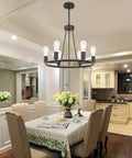 Rustic Farmhouse Round Pendant Lighting 6-Light Chandelier In Oil-Rubbed Bronze hanging above a dining table in cozy setting.