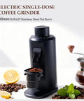 Badass Single Dose Electric Coffee Grinder Featuring Rock Solid 80 Millimeter Flat Burrs And Tweakable Stepless Adjustment For Hella Smooth Flavor Extraction And Minimal Static Residue Always Ready To Serve Black with ground coffee and coffee beans.