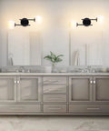 Two Light Modern Matte Black Vanity Lights With White Globe Glass Shades Industrial Farmhouse Wall Lamp mounted in bathroom.