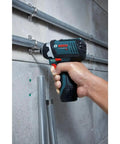 Person using 12V Max Impact Driver Kit With 930 In Lbs Torque Ultra Compact Five Point Four Inch Head For Tight Spaces Lightweight At Just Over Two Pounds No Load 3100 BPM Pro Grade Power For Everyday Jobsite Use on pipes