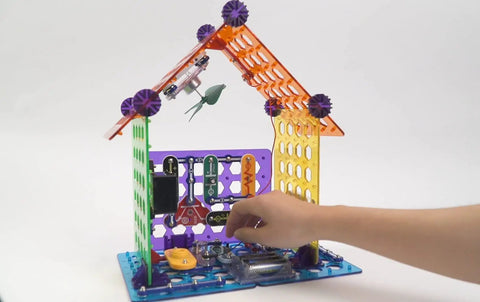 Child assembling Elenco My Home Electronics Building Kit For Kids Aged 8 And Up with colorful blocks and circuits