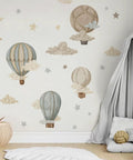 Watercolor Hot Air Balloon Fabric Wall Sticker Peel and Stick Decals With Stars and Clouds for Baby Nursery Kids Bedroom Playroom Decor 120 x 40 cm Eco Friendly Non Toxic Pre Cut Totally Kid Friendly displayed on a nursery wall with a cozy tent.