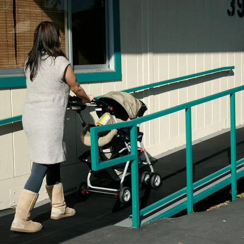 Woman pushing stroller on Ramp-Cleat Non-Slip Outdoor Rubber Mats For Durable Entryways And Walkways, One Eighth Inch Thick By 3 By 8 Feet Floor Mat With Anti-Slip Grip, Lightweight Yet Heavy-Duty, Easy Install For Seasonal Use.