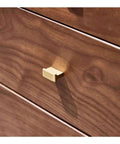 Close-up of a drawer handle on the Kickass Executive Desk With Three Smooth Drawers And Raised Monitor Stand Perfect For Your Prime Home Office Or Gaming Rig In Rich Black Walnut Wood Finish 143 Cm Wide.