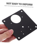 Person holding a black steel hinge plate with circular cutout, part of Six Pack Cupboard Hinge Repair Plates Kit For Quick Install Quiet Kitchen Cabinet Door Fix Secure And Stylish Cabinetry Hardware For No Slam Operation