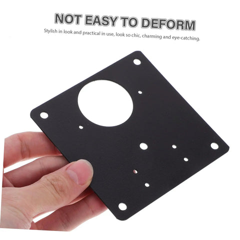 Person holding a black steel hinge plate with circular cutout, part of Six Pack Cupboard Hinge Repair Plates Kit For Quick Install Quiet Kitchen Cabinet Door Fix Secure And Stylish Cabinetry Hardware For No Slam Operation