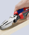 High Leverage Lineman Pliers With New England Head For Maximum Cutting Power And Superior Grip in use on wooden surface