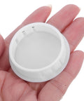 Hand holding White Plastic Hole Plugs 2 Inch Flush Snap In Locking Caps With Smooth Matte Finish Round Screw Hole Covers
