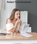 Woman using Rechargeable Travel Makeup Mirror With Light 7x5 Inch Portable Lighted Vanity Mirror 10X Magnifying LED for grooming.