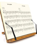 Bamboo Adjustable Book Stand With Tray And Clips, displaying an open music score, five angle positions, foldable and durable.