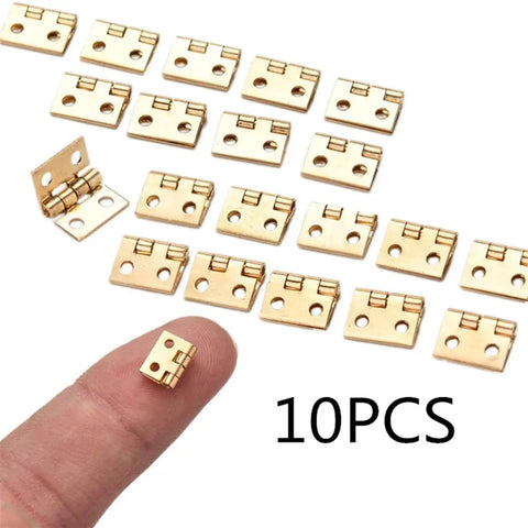 10 Pack Brass Plated Mini Hinges For Small Wooden Boxes And Cabinets on finger with 10 pieces shown