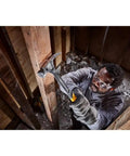 Worker using ToughSeries 22 Oz Demo Hammer with Magnetic Nail Starter for demolition in a wooden structure, showcasing one-piece steel design.