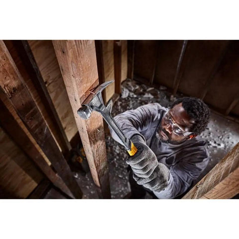 Worker using ToughSeries 22 Oz Demo Hammer with Magnetic Nail Starter for demolition in a wooden structure, showcasing one-piece steel design.