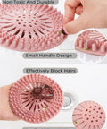 Slick Rubber Drain Stopper And Hair Catcher For Showers, Baths, And Kitchen Sinks, close-up with small handle and pink TRP material.
