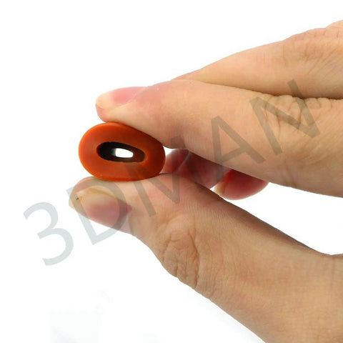 Close-up of a hand holding a silicone piece from the Heatbed Silicone Leveling Column Set for 3D Printers, 16 Pc Kit