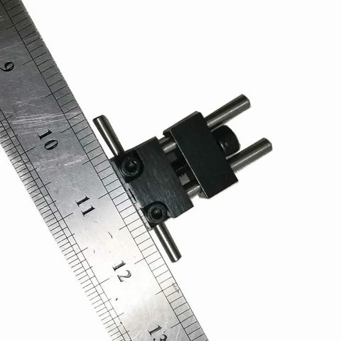 Badass Strength Precision Vise Stop Locators For CNC Milling Machines on a ruler, showcasing precise steel dimensions.