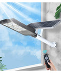 Heavy Duty Solar Outdoor Lights 50W To 300W Led Flood With Motion Sensor And Remote Control IP66 Waterproof fixture mounted on wall.