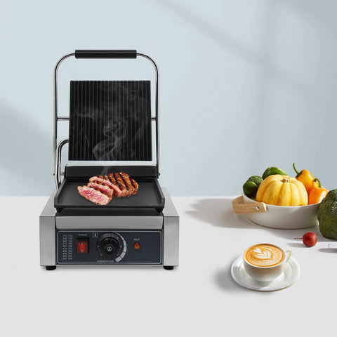 Heavy Duty Electric Panini Press Grill With 1800W Dual Heating Plates cooking grilled steaks on stainless steel grill surface.