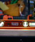 9 Inch Lighted Torpedo Level with Bright LED Vials and Powerful Magnetic Track illuminating on workbench