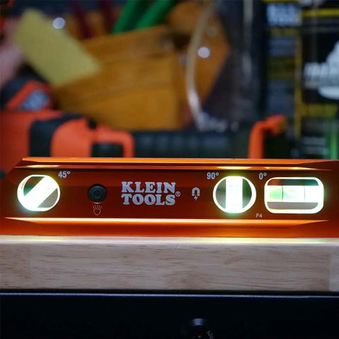 9 Inch Lighted Torpedo Level with Bright LED Vials and Powerful Magnetic Track illuminating on workbench