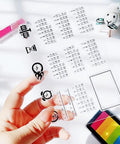 Fresh Date Week Month Year Calendar Clear Silicone Stamp Set For DIY Scrapbooking And Holiday Cards Featuring Alarm Clock Arabic Numerals Legit Quality Craft Kit held in hand showing clock and numeral designs.