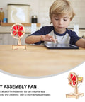 Hands On DIY Electric Fan Assembly Kit For STEM Classrooms And Science Projects on a table with a child observing.