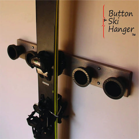 Badass Five Pack Ski Wall Hangers securely grip alpine boards on a wall mount displaying skis and clips.