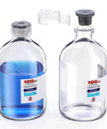 Two sterile glass vials with locking caps and injection-port components; one filled with blue liquid, 100 mL opening.