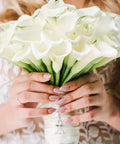 Bride holding a bouquet of white flowers with DIY Guardian Angel Pendant Kit attached, featuring 420 pieces beads and alloy wings
