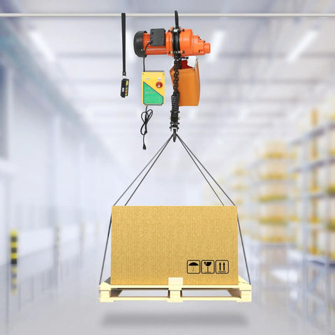 Tough As Nails 1300W Electric Chain Hoist Featuring Pure Copper Motor lifting a cardboard box from a pallet in a warehouse.