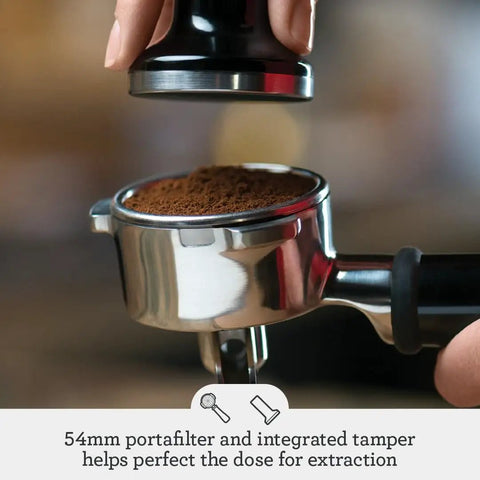 Close-up of a portafilter with ground coffee in Barista Touch Espresso Machine With Built In Grinder And One Touch Dose Control