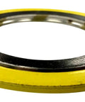Spiral-wound gasket with a yellow outer ring and silver inner ring for industrial piping.