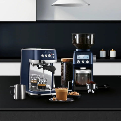 Damson Blue Kickass Espresso Coffee Maker Featuring Auto Milk Frother Quick Heat Technology And Reliable Pressure Pumping For Next Level Barista Quality Home Brews Any Day on countertop with coffee glasses.
