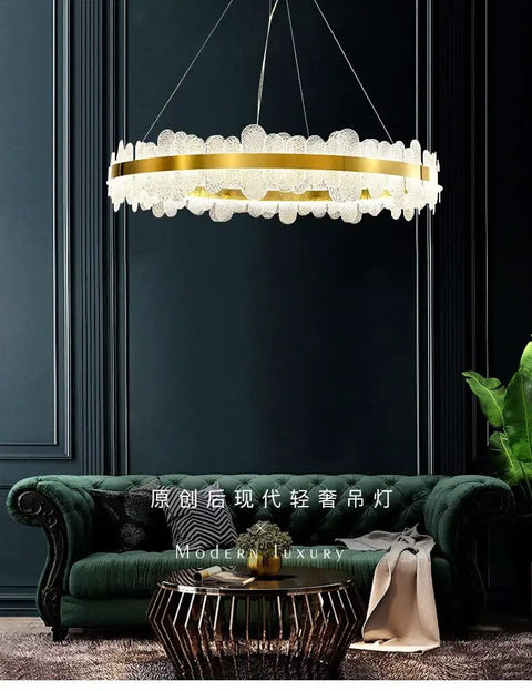 Chic Round Gold LED Pendant Light With Cut Diamond Glass Shade Dimmable Hanging Lamp For Modern Spaces Top Tier Smooth Glow Ceiling Setup Hits Different, hanging over a green sofa.