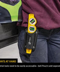 Person wearing die cast torpedo level with protractor vial and adjustable 360 degree vial in belt pouch.