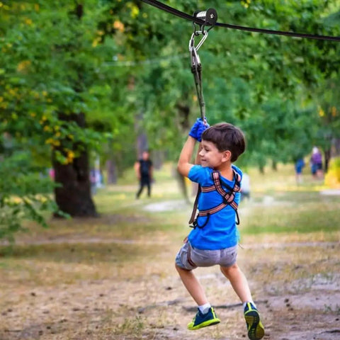 Slackline Pulley With Carabiner For Kids Backyard Zipline And Slackline Training Essentials in park setting with child using it