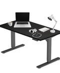 Rock Solid 72 By 30 Inch Electric Standing Desk Height Adjustable Dual Motor Sit Stand Computer Workstation with laptop and accessories.