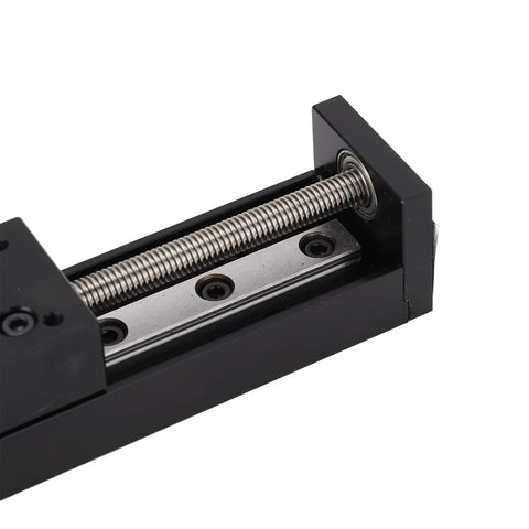 Linear slide stage actuator with black housing and silver lead screw; close-up view of guide rail and screw threads.