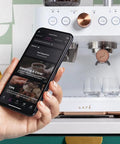 Next Level Semi Automatic Espresso Machine With Badass Built In Grinder And Silky Milk Frother Featuring WiFi App Control Custom Drinks shown with smartphone control app.