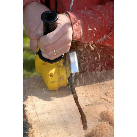 No Bull 4 Inch 14 Tooth Carving Saw Disc For Angle Grinders in use, showcasing heavy wood removal with a yellow angle grinder.