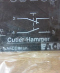 Cutler Hammer CHE22B11 black contact block with electrical symbols and labels for high amp switch module use.